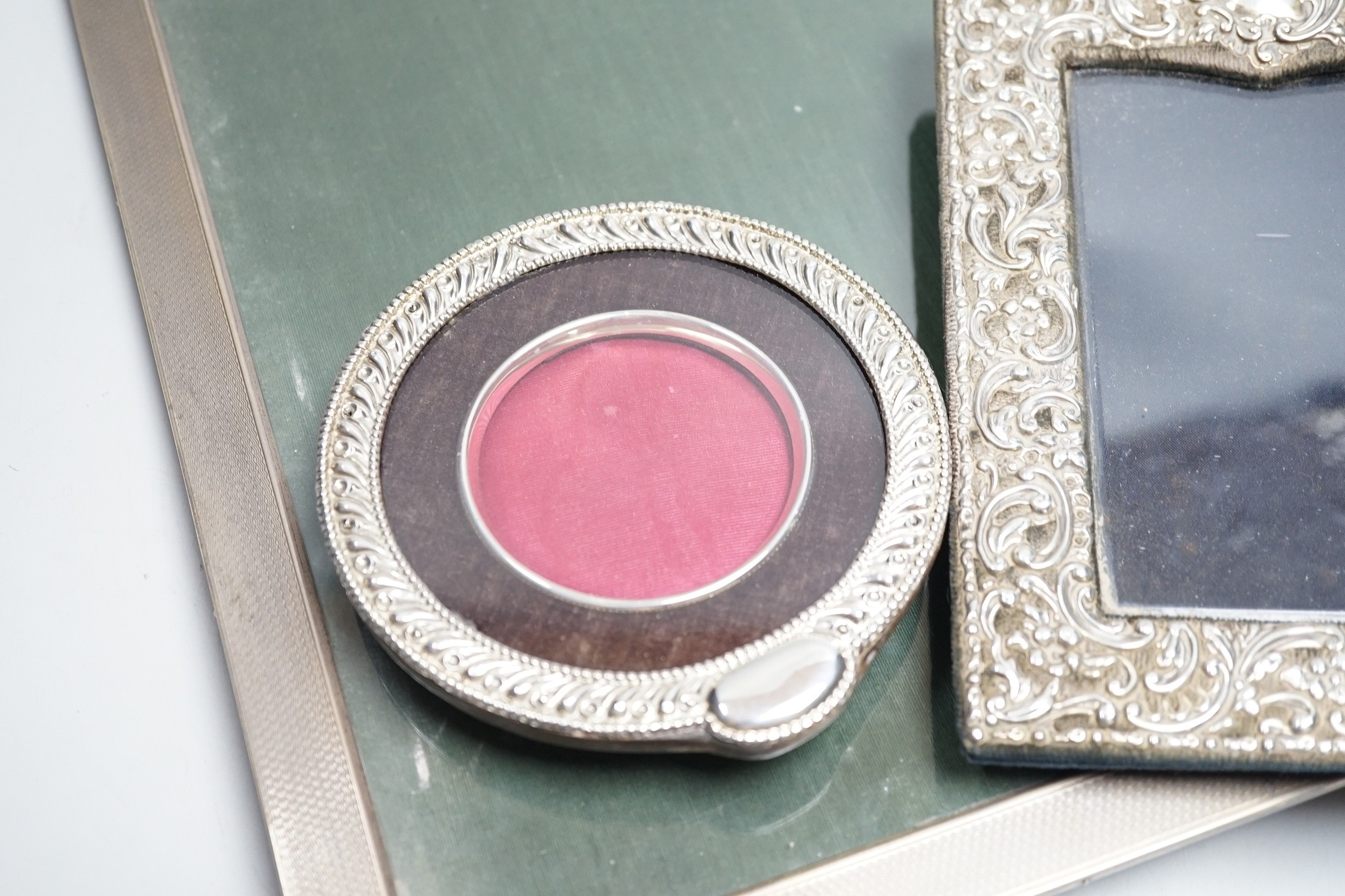 A large 1920's engine turned silver mounted rectangular photograph frame, Birmingham, 1928, 33.2cm and two other silver mounted photograph frames including circular.